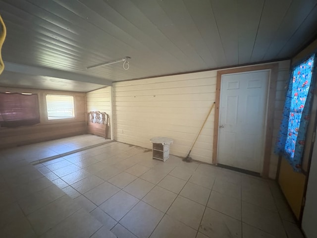 1169 County Road 619, Kirbyville, TX 75956 - spare room featuring wooden walls and tile patterned flooring