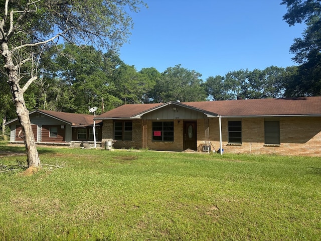 1169 County Road 619, Kirbyville, TX 75956 - view of front of house featuring a front yard and brick siding