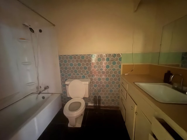 1169 County Road 619, Kirbyville, TX 75956 - full bathroom featuring tile walls, toilet, wainscoting, vanity, and bathing tub / shower combination