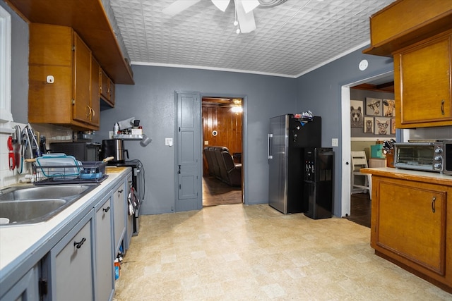 505 S Home St, Corrigan, TX 75939 - kitchen featuring ceiling fan, freestanding refrigerator, light countertops, an ornate ceiling, and brown cabinetry