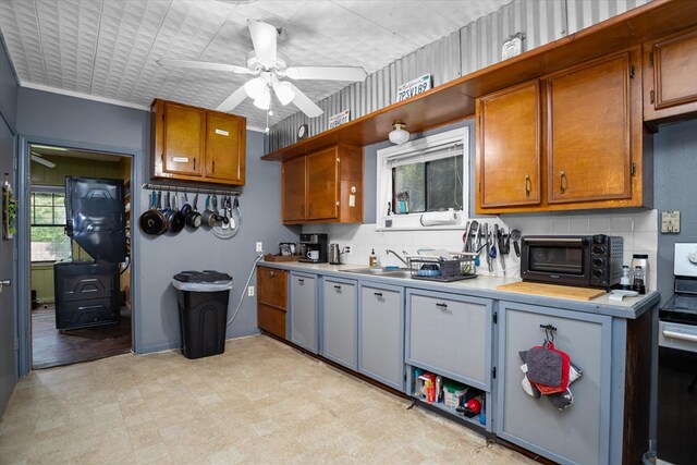 505 S Home St, Corrigan, TX 75939 - kitchen with light countertops, stainless steel range with electric stovetop, and brown cabinetry