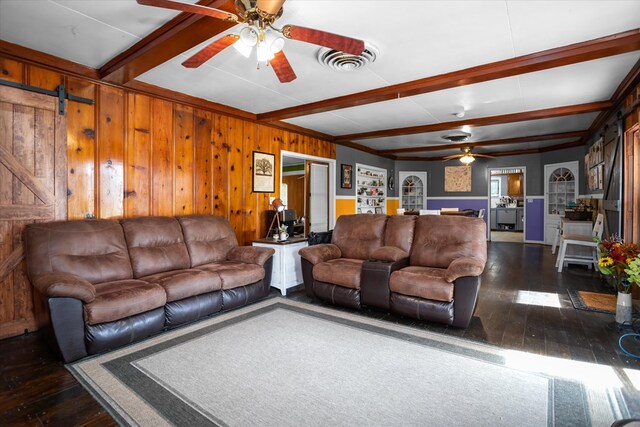 505 S Home St, Corrigan, TX 75939 - living area featuring ceiling fan, dark wood-style floors, beam ceiling, a barn door, and wood walls