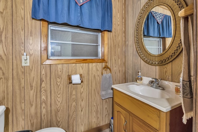 211 Winfree Dr, Hemphill, TX 75948 - half bathroom with toilet, vanity, and wooden walls