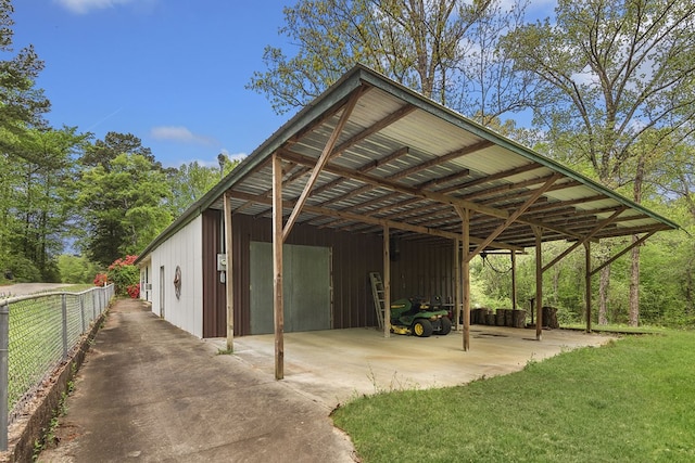 211 Winfree Dr, Hemphill, TX 75948 - view of parking / parking lot with a pole building, a garage, a carport, and fence