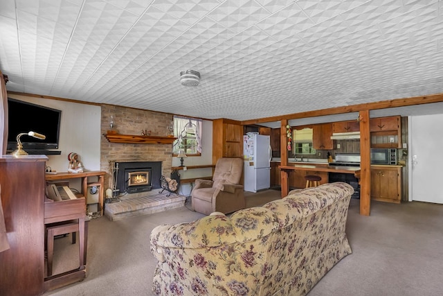 211 Winfree Dr, Hemphill, TX 75948 - living room with plenty of natural light, light colored carpet, and a fireplace