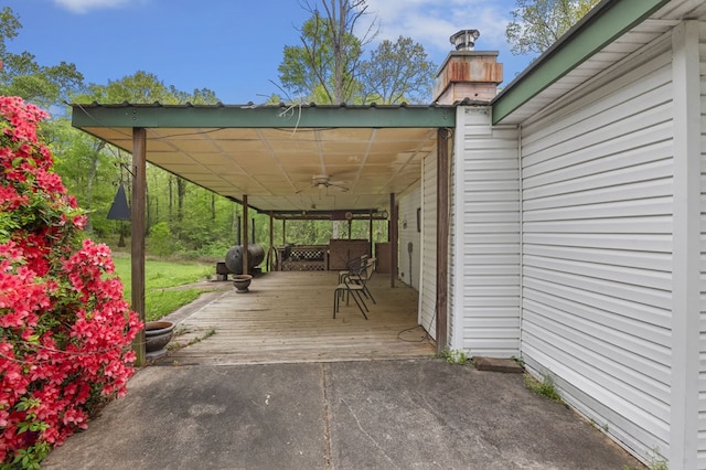 211 Winfree Dr, Hemphill, TX 75948 - view of patio / terrace with concrete driveway, a ceiling fan, a wooden deck, a carport, and grilling area