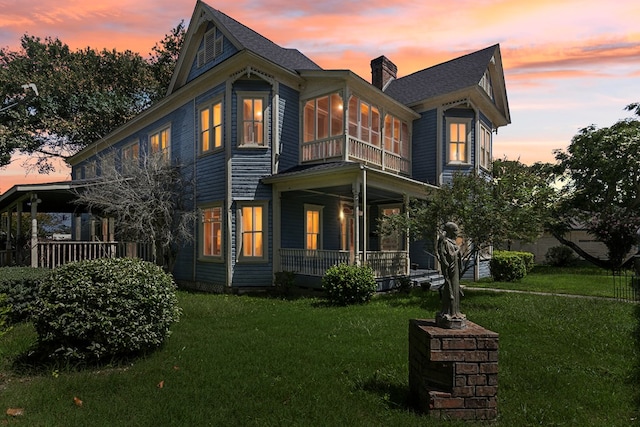 250 Main St, Jasper, TX 75951 - view of front of home with covered porch, a lawn, and a chimney