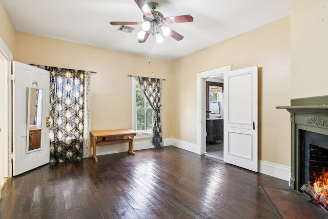 250 Main St, Jasper, TX 75951 - unfurnished living room with a fireplace with flush hearth, hardwood / wood-style floors, ceiling fan, and baseboards
