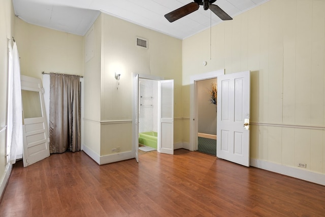 250 Main St, Jasper, TX 75951 - unfurnished bedroom featuring wood finished floors, ceiling fan, baseboards, and a towering ceiling