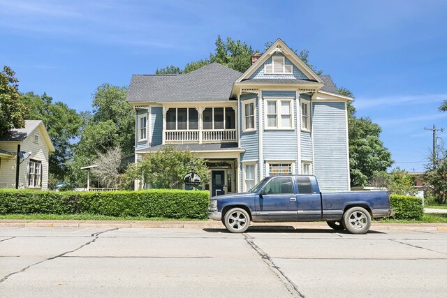 250 Main St, Jasper, TX 75951 - victorian home featuring a chimney and a shingled roof
