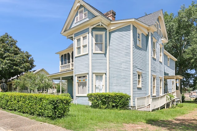 250 Main St, Jasper, TX 75951 - view of front of house with a chimney and a balcony