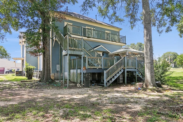 250 Main St, Jasper, TX 75951 - back of property with stairway, a wooden deck, and a gazebo