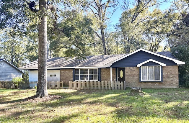 ranch-style house featuring a garage and a front lawn