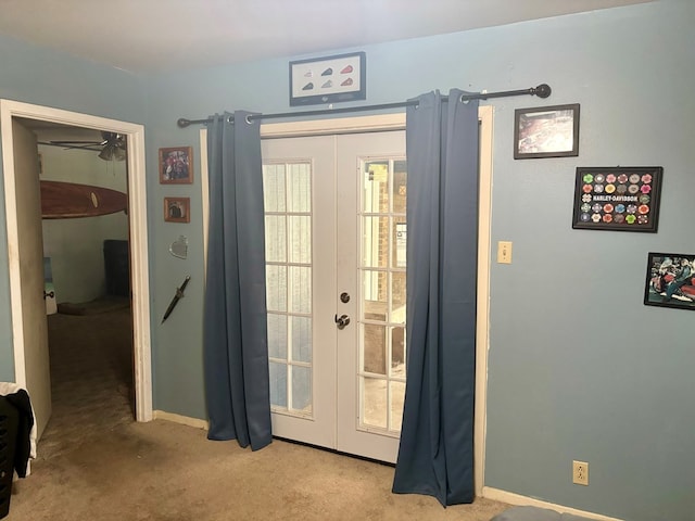 doorway to outside featuring french doors and light colored carpet