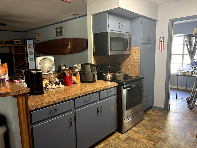 kitchen featuring gray cabinetry, decorative backsplash, and stainless steel appliances