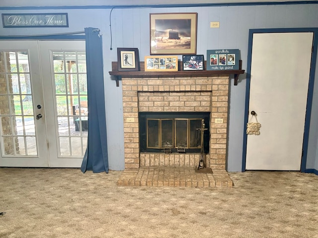 carpeted living room with a brick fireplace and french doors