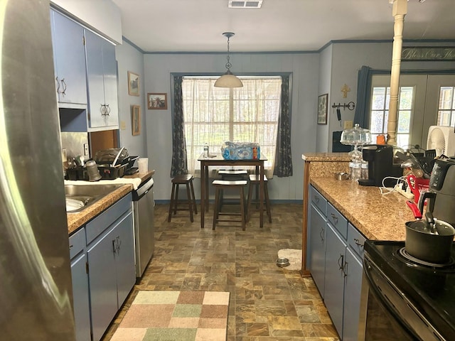 kitchen with gray cabinets, a healthy amount of sunlight, and hanging light fixtures