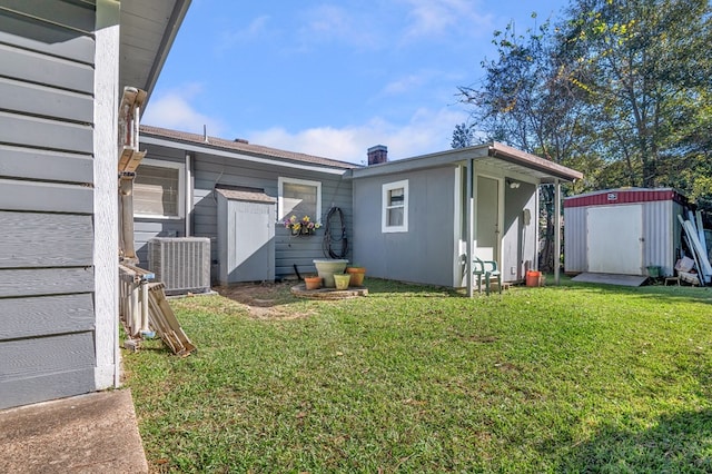 exterior space with a yard, cooling unit, and a storage shed