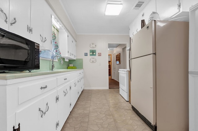 kitchen with white appliances, crown molding, sink, white cabinets, and light tile patterned flooring