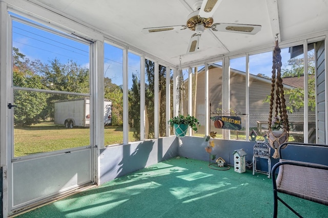 unfurnished sunroom with ceiling fan