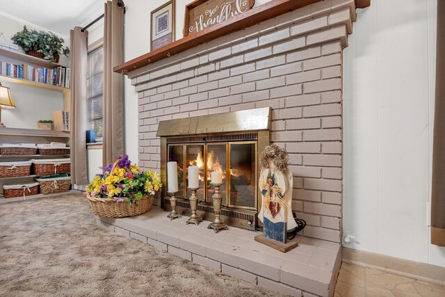 room details featuring a fireplace, carpet floors, and crown molding