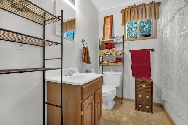 bathroom with vanity, toilet, and crown molding