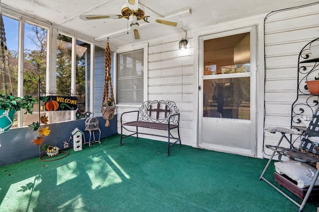 sunroom / solarium featuring ceiling fan