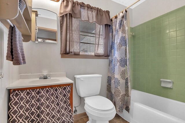 full bathroom with tile patterned floors, vanity, shower / bath combo with shower curtain, crown molding, and toilet