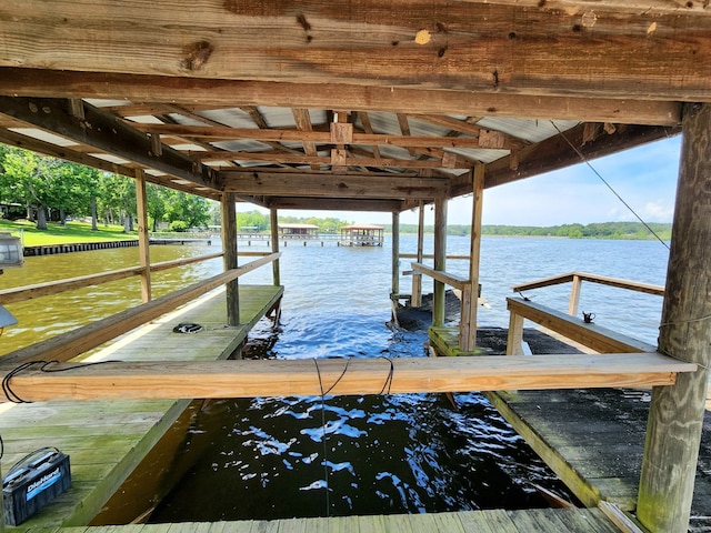 dock area with a water view and boat lift