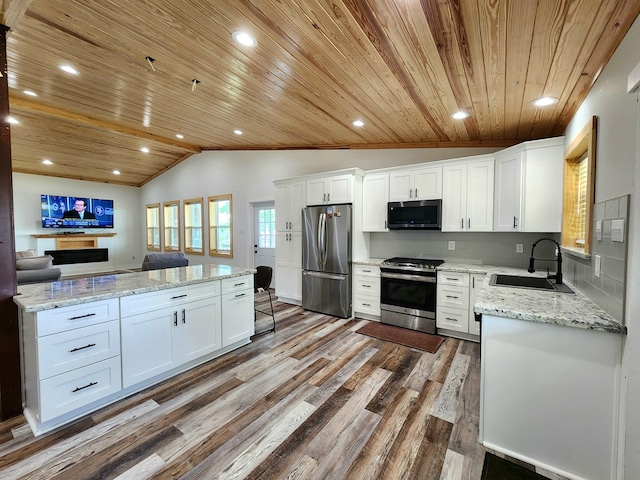 kitchen featuring a sink, stainless steel appliances, vaulted ceiling, wood ceiling, and wood finished floors
