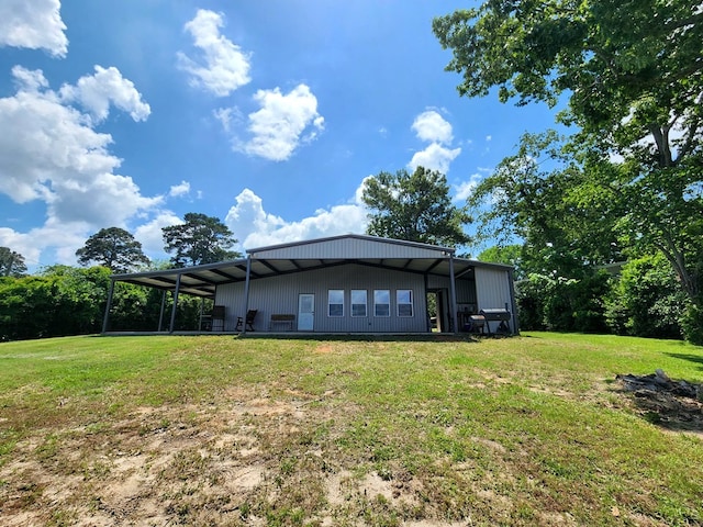 back of house with a lawn