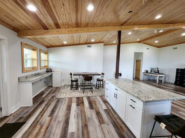 kitchen featuring wood ceiling, dark wood-type flooring, white cabinetry, and light stone countertops