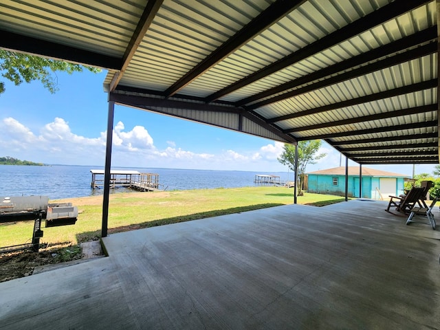 view of patio featuring a water view and a dock