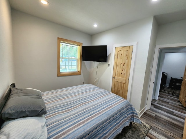 bedroom with dark wood-style floors, recessed lighting, and baseboards