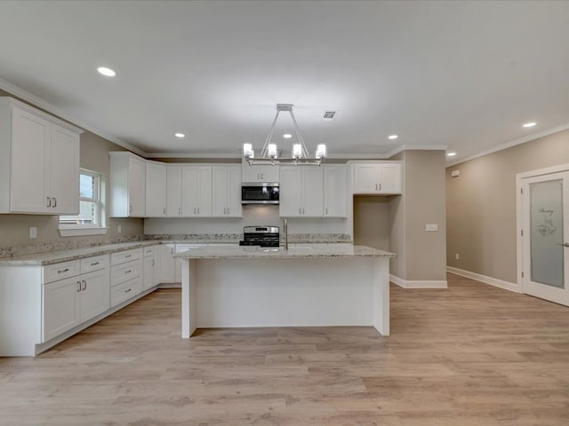 kitchen featuring crown molding, white cabinetry, stainless steel appliances, and recessed lighting