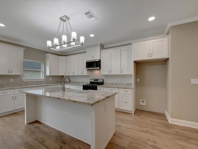 kitchen featuring ornamental molding, white cabinets, and appliances with stainless steel finishes