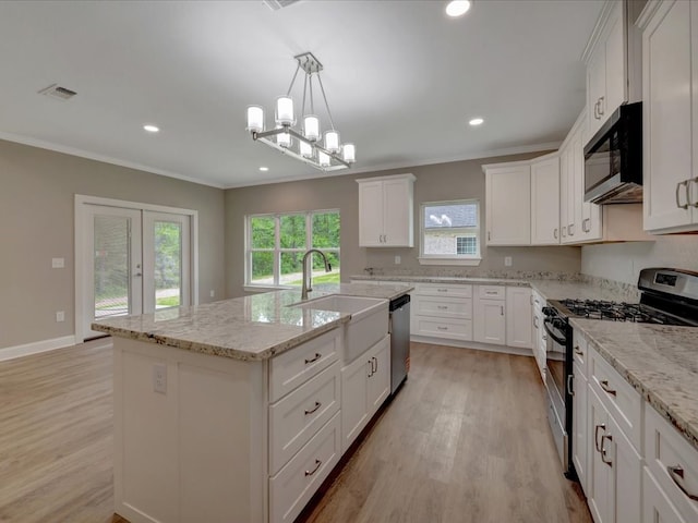 kitchen with a sink, stainless steel appliances, crown molding, light wood finished floors, and white cabinetry