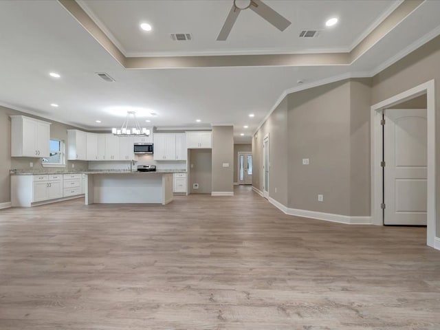 kitchen with stainless steel appliances, white cabinets, crown molding, and visible vents