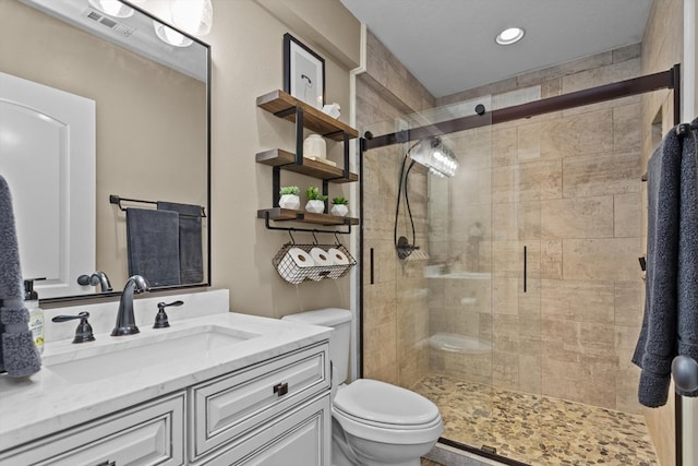 bathroom featuring vanity, toilet, and walk in shower