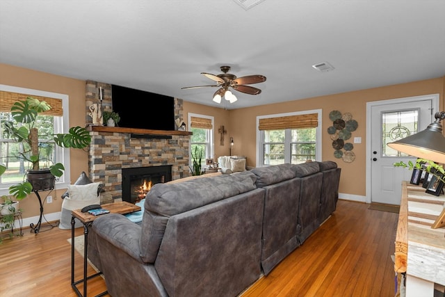 living room with ceiling fan, a fireplace, and hardwood / wood-style floors