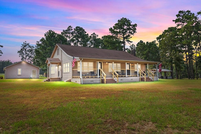 view of front of property featuring a yard and covered porch