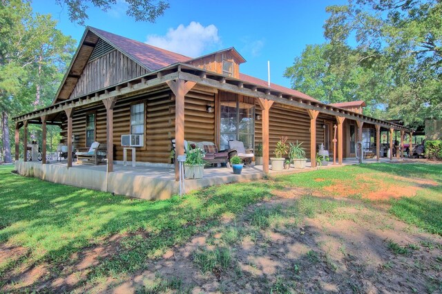 rear view of house with a patio area, a yard, and cooling unit