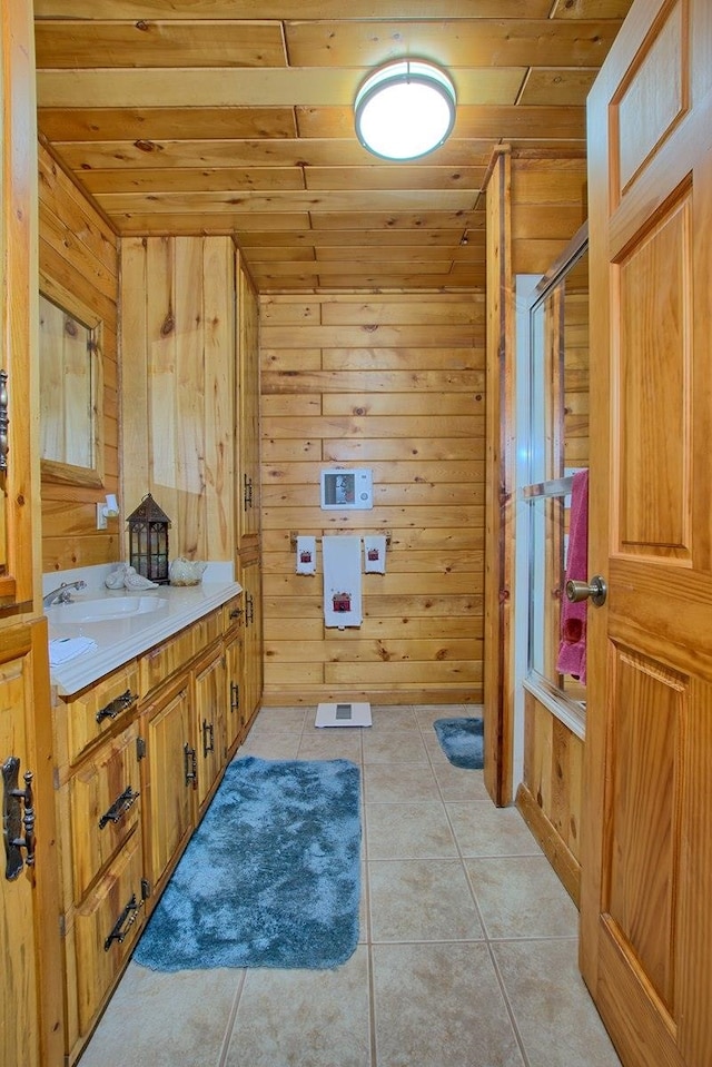 bathroom featuring tile patterned floors, a shower, wooden walls, vanity, and wood ceiling