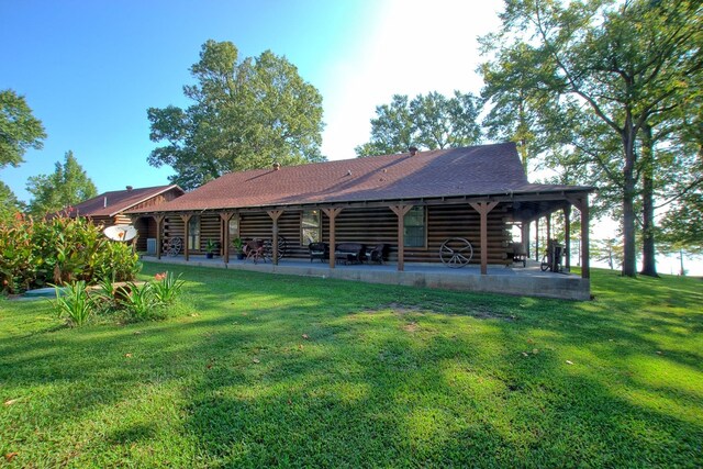 rear view of house with a yard and a patio