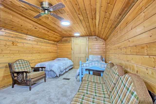 bedroom featuring ceiling fan, wood walls, lofted ceiling, and wooden ceiling