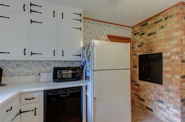 kitchen featuring white cabinets, tile patterned floors, brick wall, and black appliances