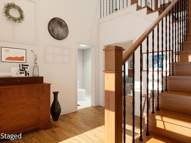 12 Columbia Ct, Lufkin, TX 75901 - stairs with wood finished floors, a towering ceiling, and baseboards
