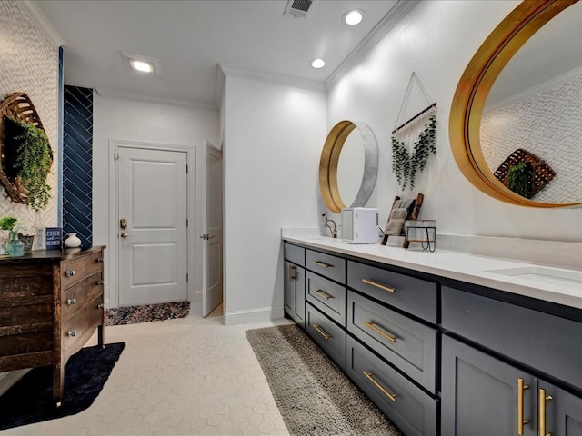 bathroom featuring tile patterned flooring, vanity, and crown molding