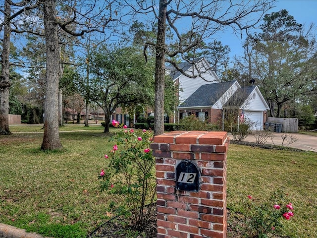 12 Columbia Ct, Lufkin, TX 75901 - view of grassy yard with driveway and an attached garage