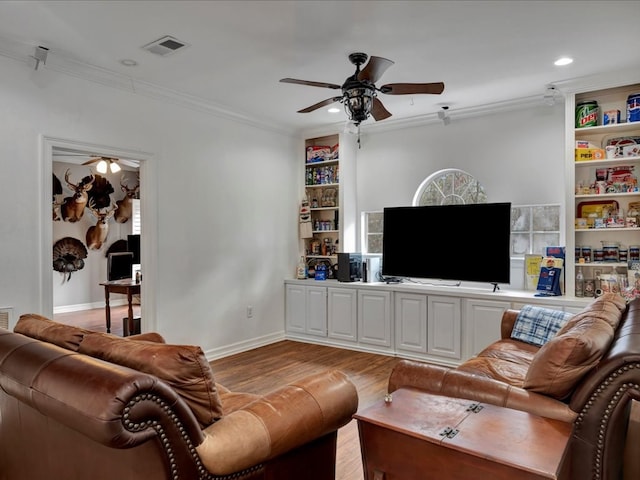 living room with light wood-type flooring and ornamental molding